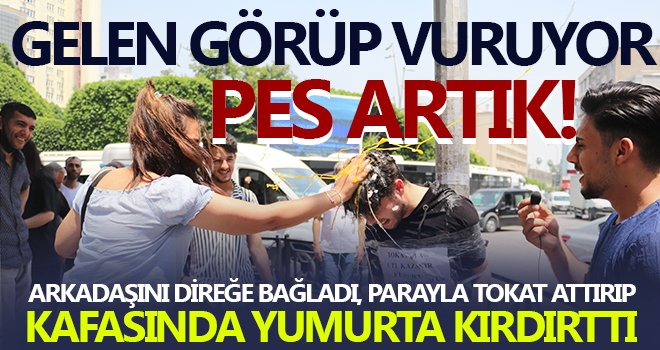 Arkadaşını direğe bağladı, parayla tokat attırıp, kafasında yumurta kırdırttı