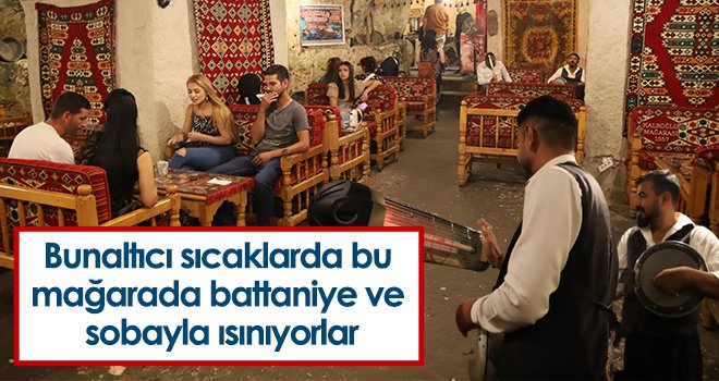 Bunaltıcı sıcaklarda bu mağarada battaniye ve sobayla ısınıyorlar